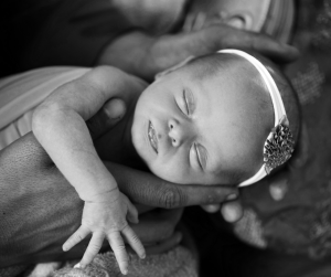Newborn photography in Daddy's strong arms